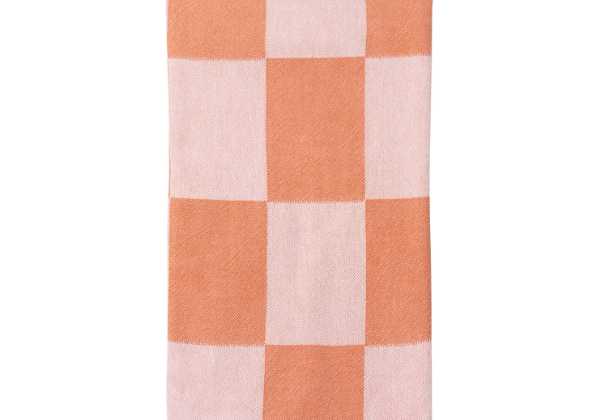 Checkered towel with coral and pink squares on a white background