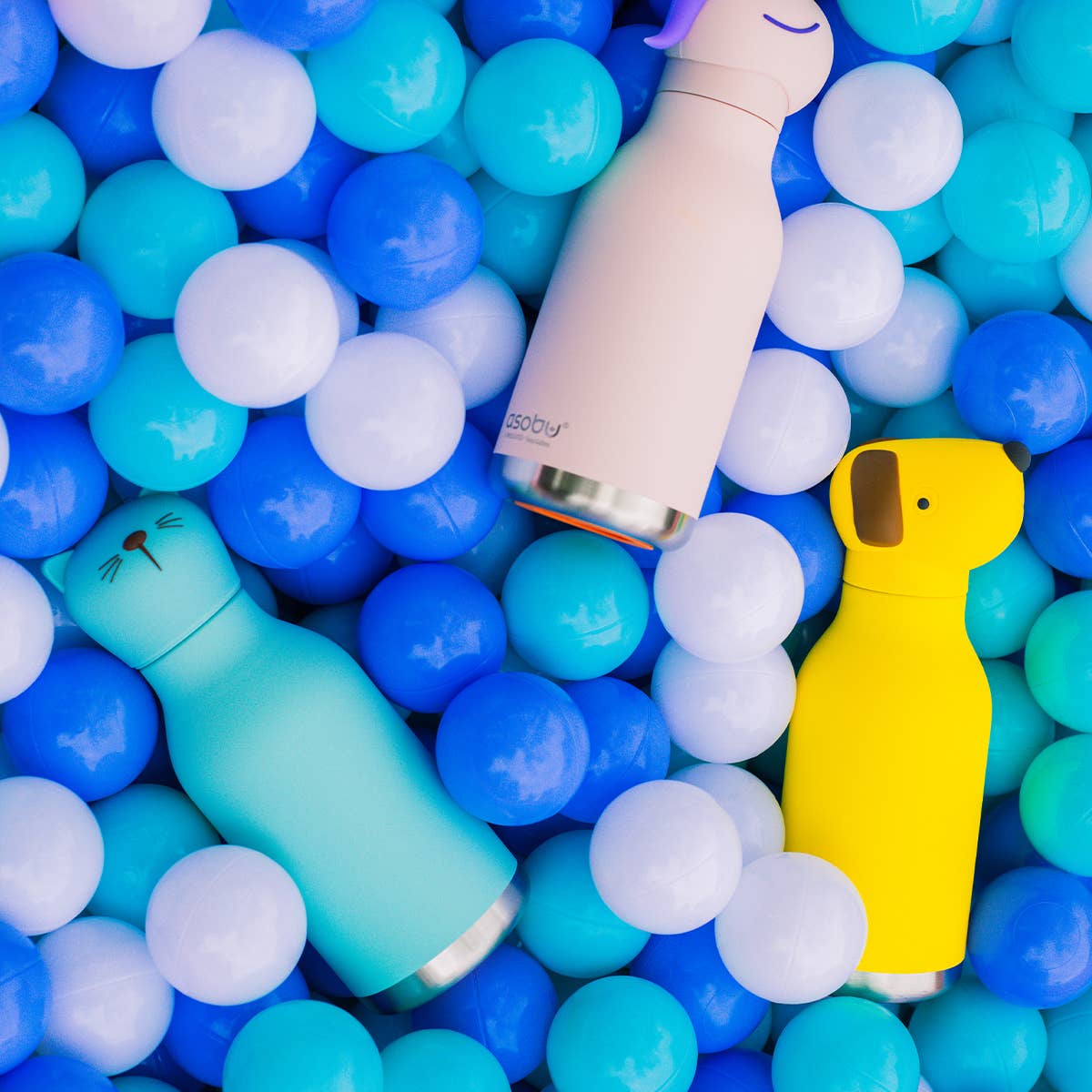 Two water bottles, one blue and one yellow, surrounded by colorful plastic balls.