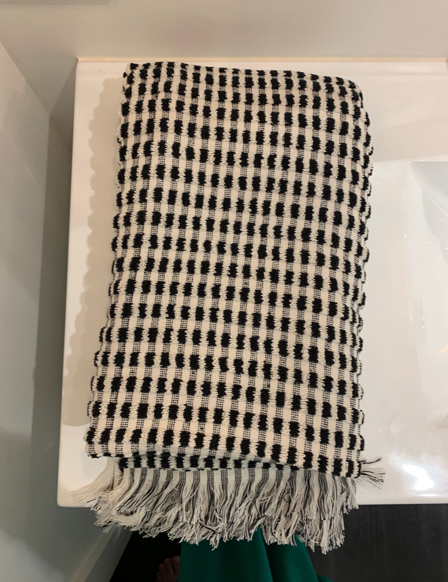 Folded large black and white dotted fluffy cotton bath towel with fringes 