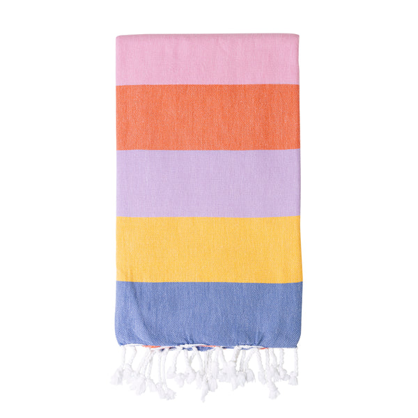 Multicolored striped Turkish towel with tassels folded on a white background, the colours are pink, orange, purple, yellow and blue.