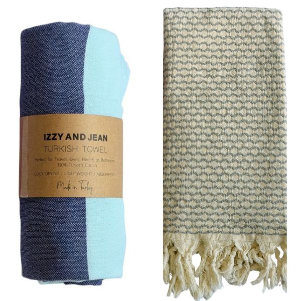 Navy and MInt Santorini Turkish towel with 'Izzy and Jean' label and an Anatolia Turkish towel with a geometric pattern on a white background
