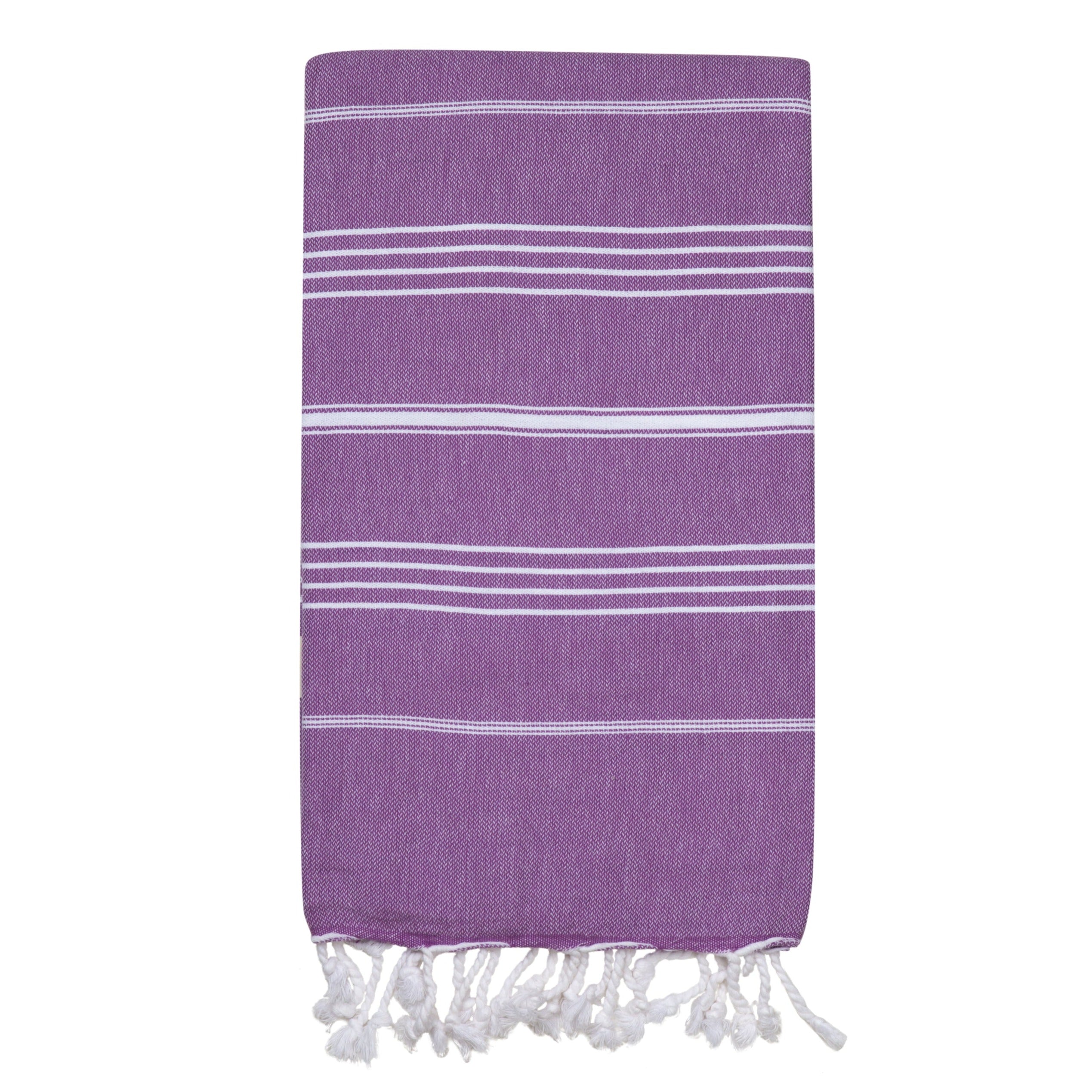 A purple Turkish towel with small white stripes folded on a blank white background