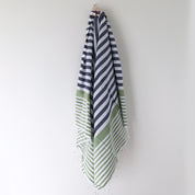 A hanging stylish Turkish towel in blue, white and green stripes.