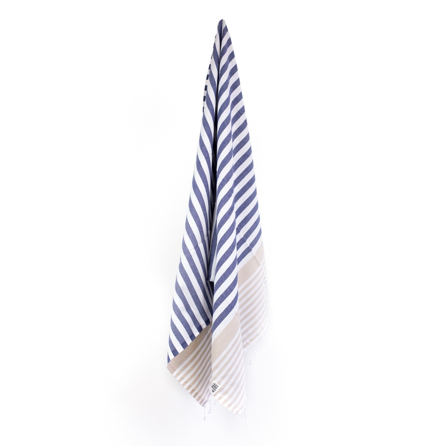 A Navy and Sand striped Sofia Turkish Towel with tassles at the bottom hanging on a hook with a plain white background