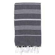 A folded black Turkish towel with white stripes and fringes on the bottom