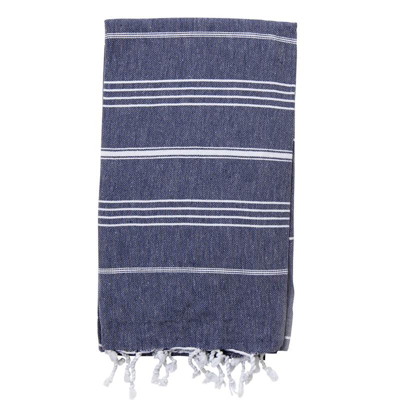 A folded navy blueTurkish towel with white stripes and fringes on the bottom
