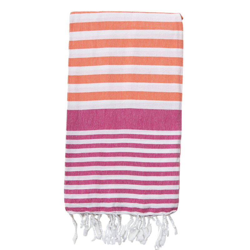 A coral and fuchsia Sofia Turkish Towel with white stripes and tassles.